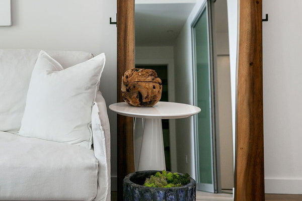 This smoky walnut floor mirror makes a dramatic impression. The mirror itself is flanked by two panels of live-edge wood, a sculptural detail that ensures this piece stands as a work of art you can use and appreciate every day. Convenient hooks provide a place to hang everyday essentials like handbags.